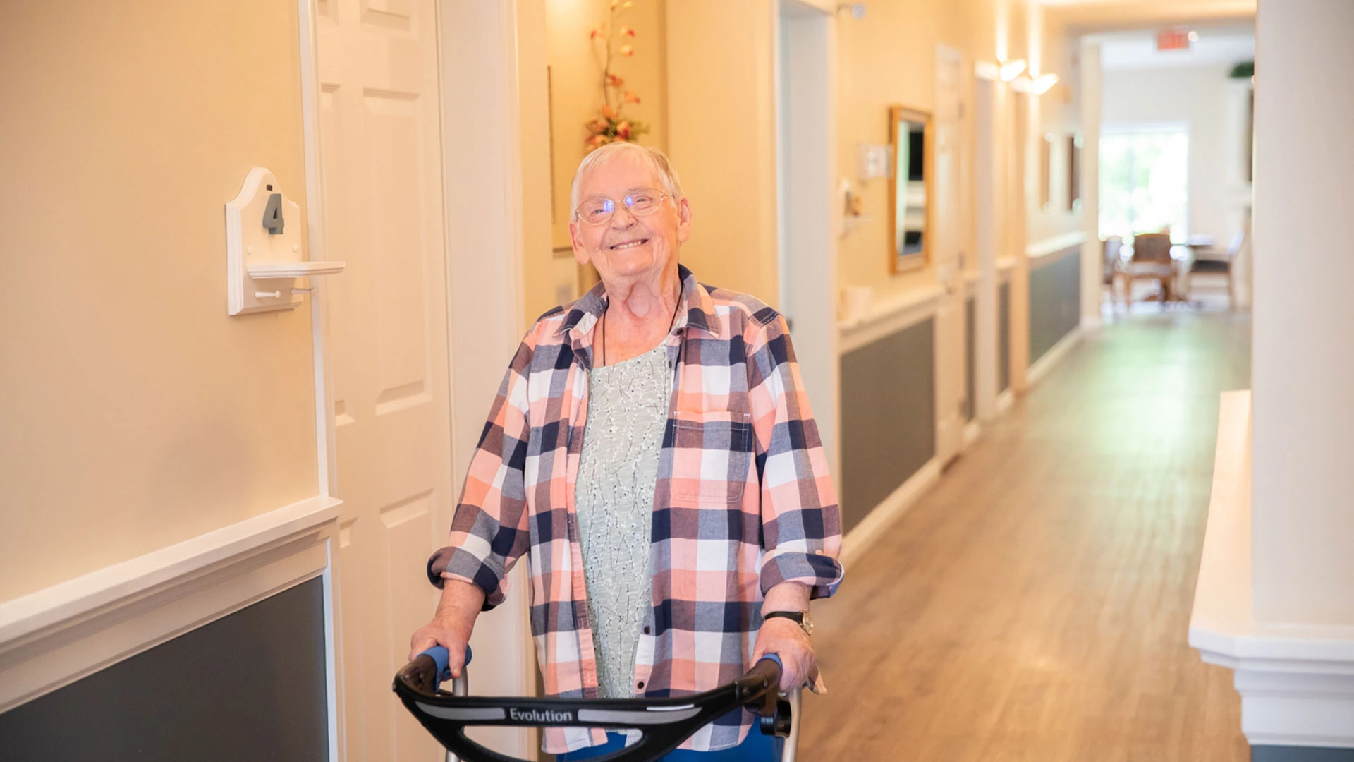Senior in a hallway smiling